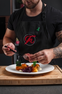 Dineindulge private chef plating up a fillet of beef