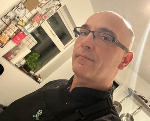 Dineindulge Chef On Mental Health Awareness Day Dineindulge private chef wearing a badge on mental health awareness day